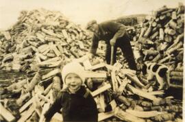 Matthew Symonds and A Man on A Wood Pile in Biggar, Saskatchewan