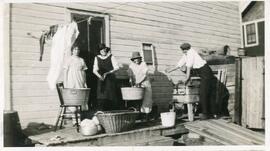 Four people doing laundry