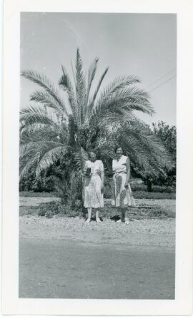 Two Women In Front of Palm Tree