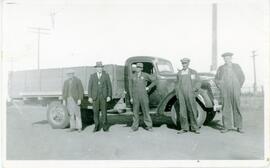 Five men In Front Of A Truck