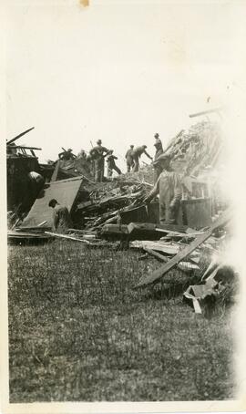 Group of Men Standing With Some Train Wreckage