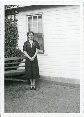 Woman Standing By House