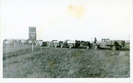 Trucks and Wagons In Line At Grain Elevator