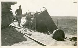 Three Men In Front of Train Wreckage