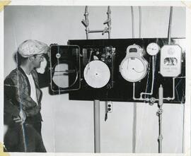 A Man Looking At Gauges At Water Filtration Plant