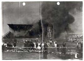 View of the Grandstand just before it fell and the Industrial Building on fire