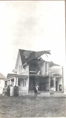 People in front of damaged house