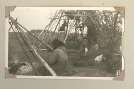 Indigenous people sitting in camp
