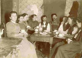 Unknown family gathering around a table