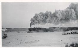 Passenger train steaming out of Beatty, Sask.
