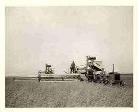 Unidentified man standing on combine