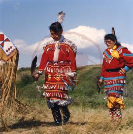 Two jingle dress dancers in ceremonial procession