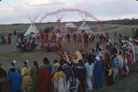 Audience and dancers surrounding two groups of singers and drummers