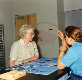Technician speaking to a visitor in archaeology lab