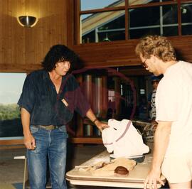 Sculptor Lloyd Pinay discussing artisanship with visitor