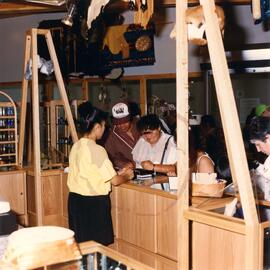 Salesperson assisting visitors in gift shop