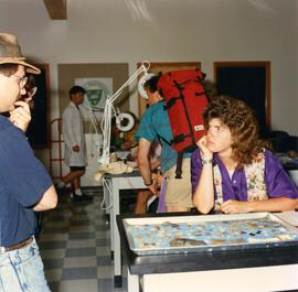 Technician showing artifacts to visitors in archaeology lab