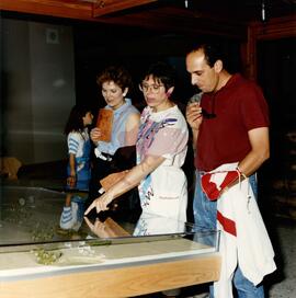 Three visitors examining the model of the park