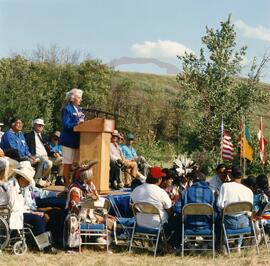 Peggy McKercher at podium of official opening ceremony