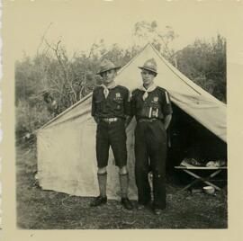 Two uniformed scouts standing in front of a tent