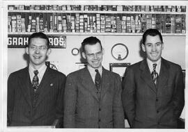 Three men in radio department of Graham Bros. Store