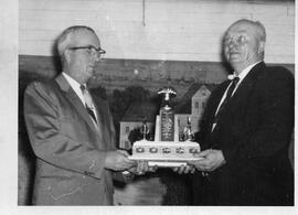Clarence Kerr and Albert Kessel holding award trophy