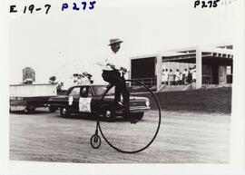 Postmaster, Harold Marfell on bicycle in parade