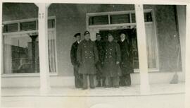 Five uniformed men standing outside