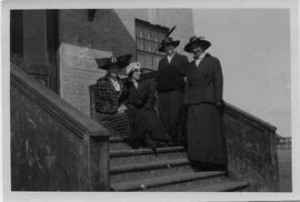 Four women on steps of early Pres. Church in Rosetown