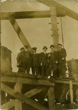 Six men standing on a platform