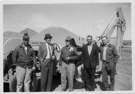 5 men standing in front of John Deere backhoe