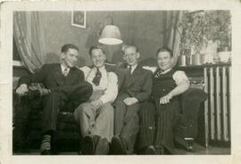 Four young men seated on a sofa