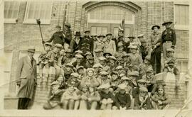 Boy Scouts and leaders on steps of Stewart School