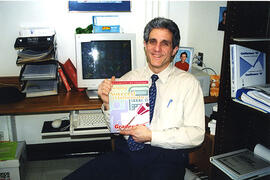 Marcel D'Eon displays the book he produced on math for low achievers