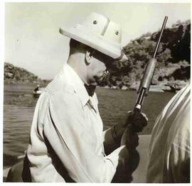 John Diefenbaker on a boat with rifle