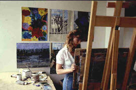 [Student painting at easel]