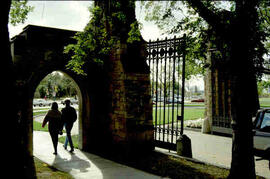 Students walking out through memorial gates in silhouette