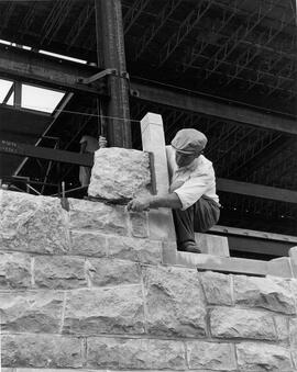 Masonry Worker Working With Stone