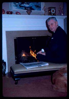 John Diefenbaker sitting by fireplace