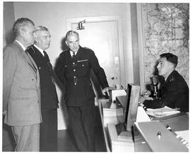 John Diefenbaker with others touring police headquarters, London, England