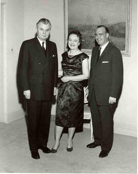 John Diefenbaker and Olive Diefenbaker standing with guest at a Christmas Party