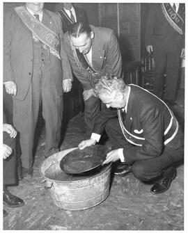 John Diefenbaker panning gold at a ceremony presenting the Yukon Order of Pioneers in Dawson City