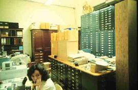 Woman in office with specimen drawers