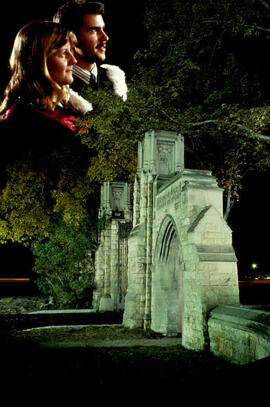 Night view of memorial gates with students superimposed