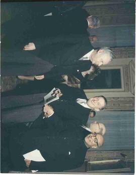 John Diefenbaker speaking with others at a reception