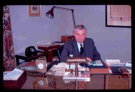 John Diefenbaker sitting at desk; Centre Block office
