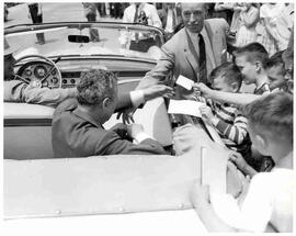 John Diefenbaker signing autographs for young boys