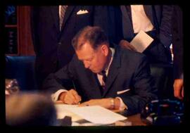 Unknown man, signing documents