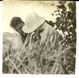 John Diefenbaker sitting in a field