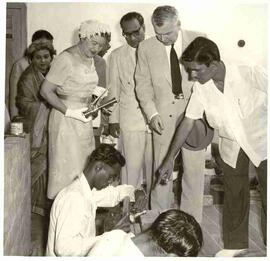 John and Olive Diefenbaker watching a craftsman in Pakistan